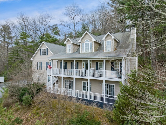 view of front of home with a porch and a balcony