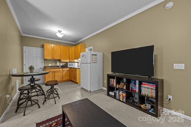 kitchen with white appliances, crown molding, light tile patterned floors, and light brown cabinets