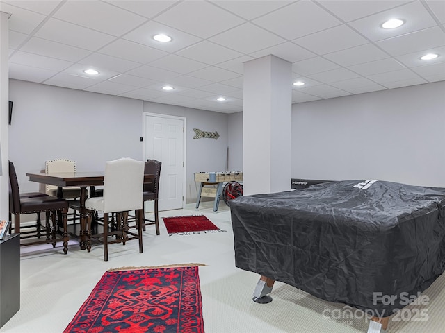 game room with pool table, light colored carpet, and a drop ceiling