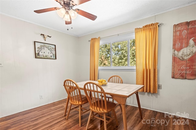 dining space featuring ceiling fan, dark hardwood / wood-style floors, crown molding, and a textured ceiling