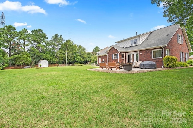 view of yard featuring a shed and a patio