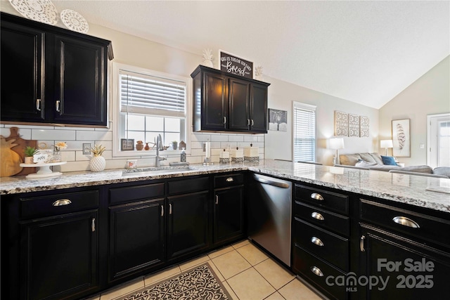 kitchen with decorative backsplash, stainless steel dishwasher, vaulted ceiling, sink, and light tile patterned flooring