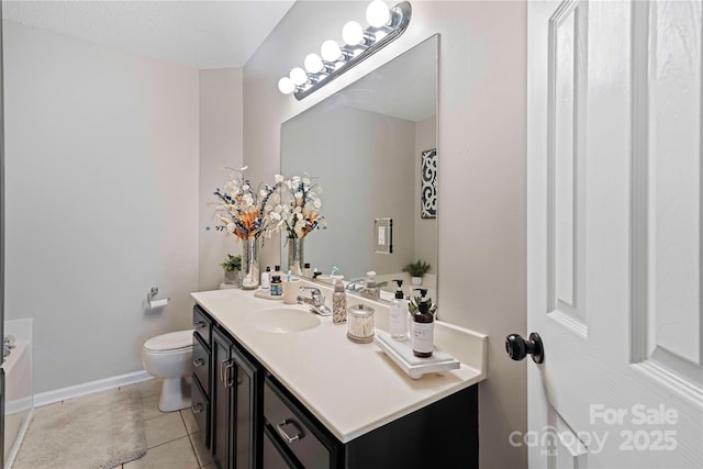 bathroom featuring tile patterned floors, vanity, and toilet