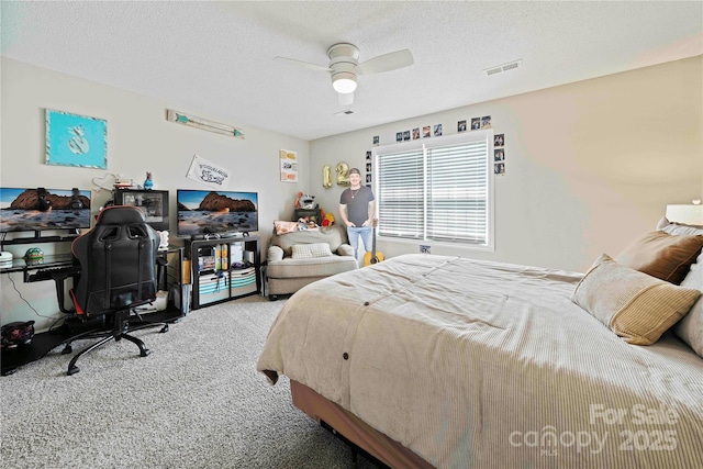 bedroom with carpet, ceiling fan, and a textured ceiling