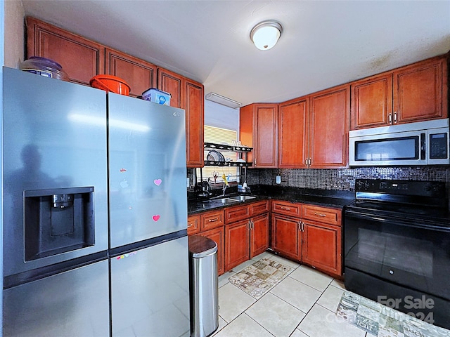 kitchen featuring appliances with stainless steel finishes, light tile patterned floors, tasteful backsplash, and sink