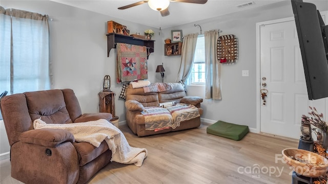 living room featuring ceiling fan and light wood-type flooring