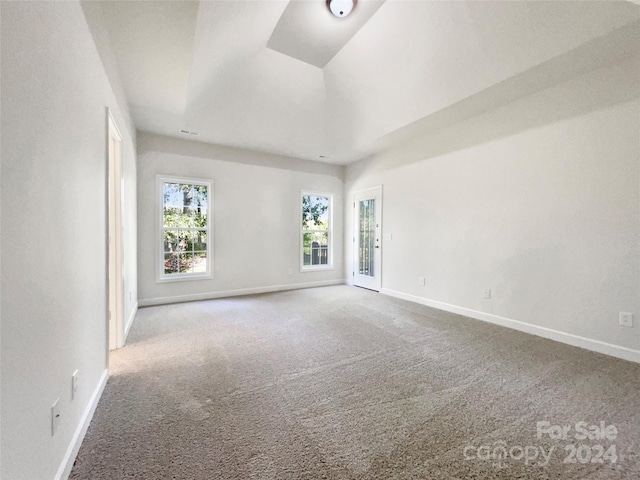 empty room featuring carpet and baseboards