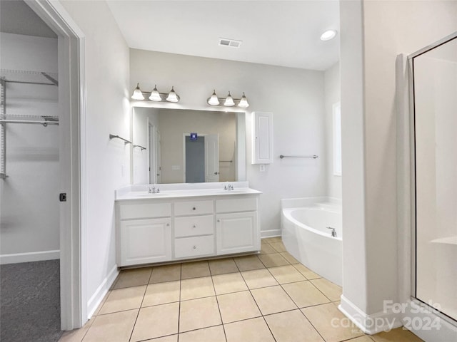 bathroom with plus walk in shower, tile patterned flooring, and vanity