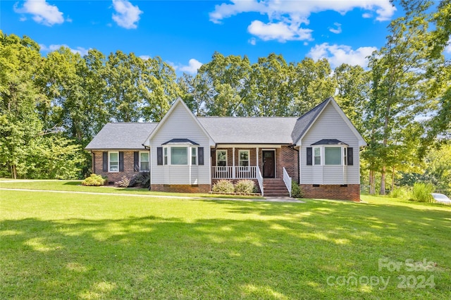 ranch-style home featuring a porch and a front lawn