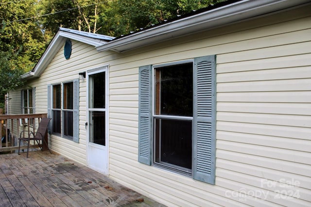 view of side of property featuring a wooden deck