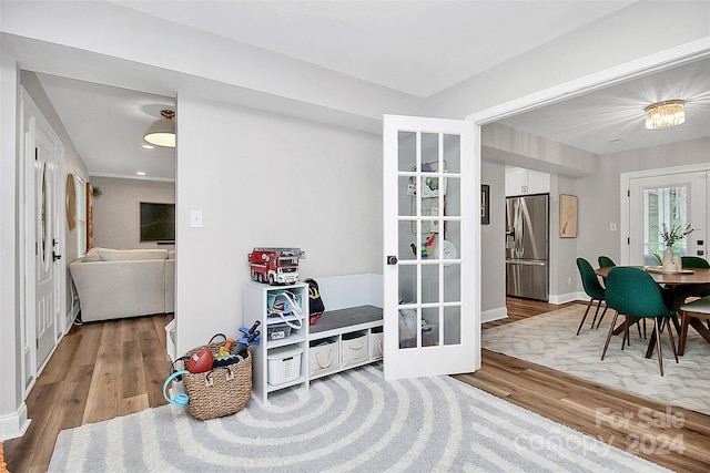 interior space with light hardwood / wood-style flooring and french doors