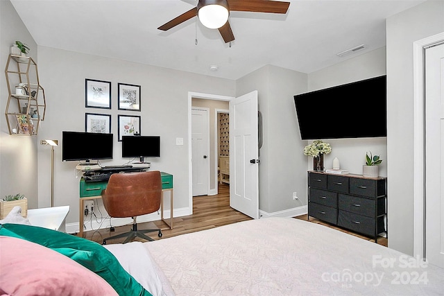 bedroom with hardwood / wood-style floors and ceiling fan