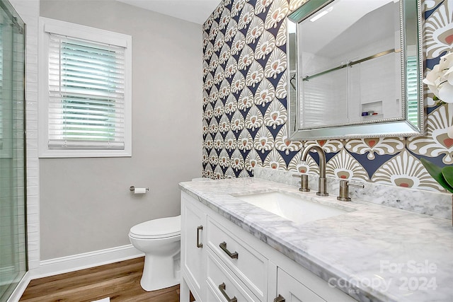 bathroom featuring an enclosed shower, wood-type flooring, toilet, and vanity