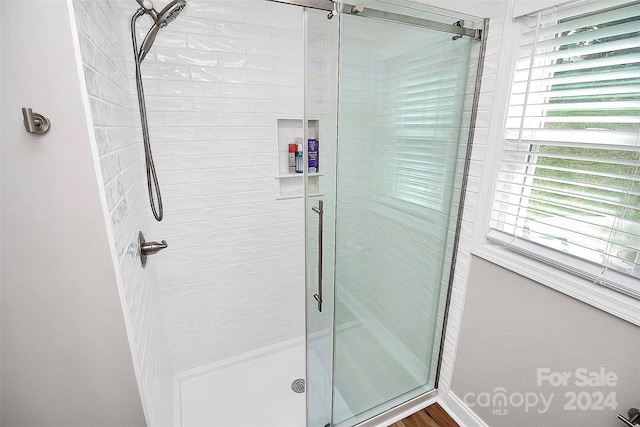 bathroom with a shower with shower door