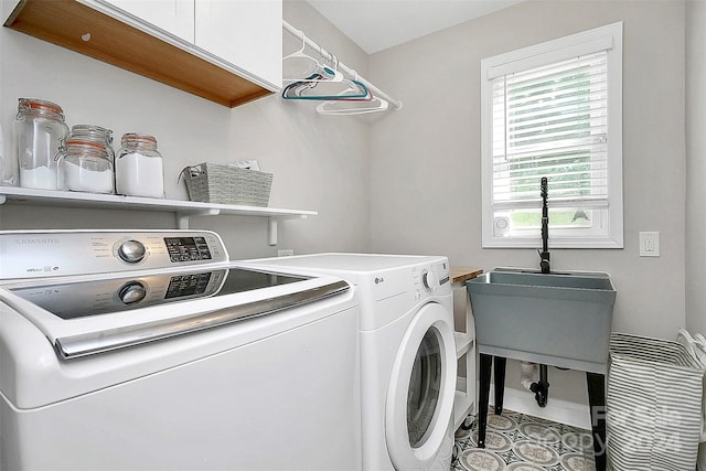 laundry room featuring light tile patterned floors, sink, cabinets, and separate washer and dryer