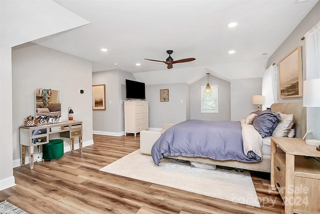 bedroom with lofted ceiling, ceiling fan, and wood-type flooring