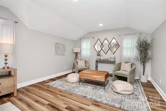 living area featuring plenty of natural light and hardwood / wood-style flooring