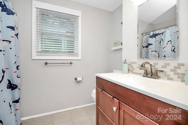 bathroom featuring tile patterned flooring, vanity, toilet, and backsplash