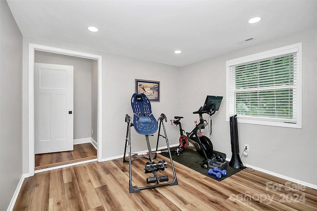 workout room featuring light wood-type flooring