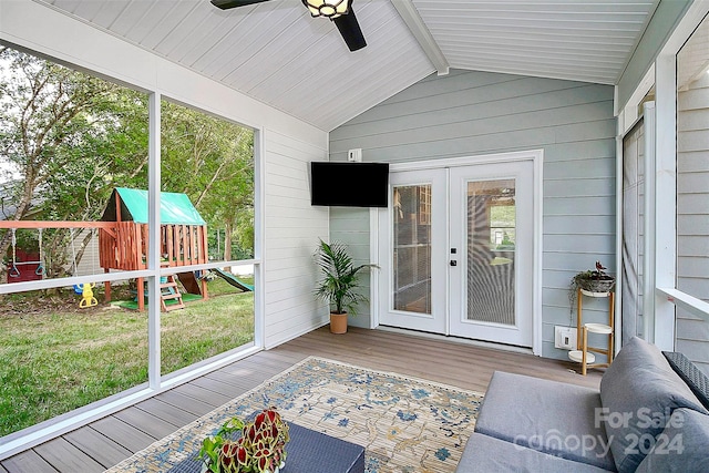 unfurnished sunroom with ceiling fan, plenty of natural light, lofted ceiling with beams, and french doors