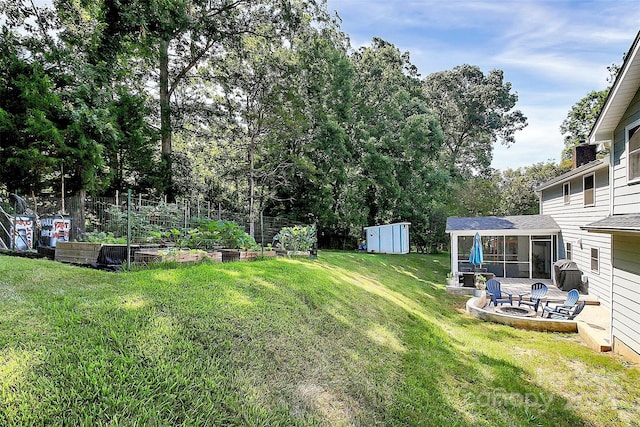 view of yard with a storage unit and a sunroom