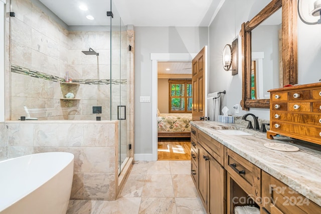 bathroom with wood-type flooring, vanity, and separate shower and tub