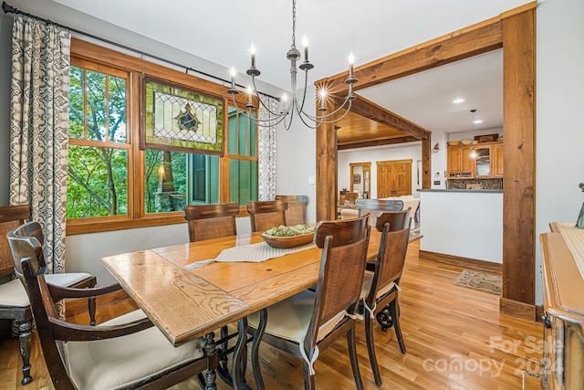 dining space featuring a notable chandelier and light hardwood / wood-style floors