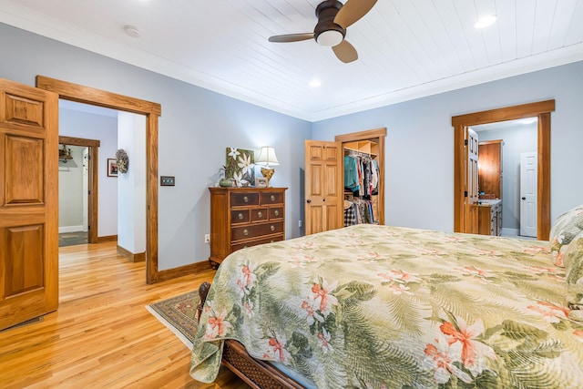 bedroom featuring ceiling fan, wood ceiling, a walk in closet, a closet, and light wood-type flooring