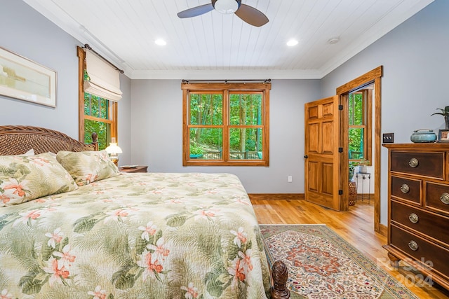 bedroom featuring light hardwood / wood-style flooring, wood ceiling, ceiling fan, and ornamental molding