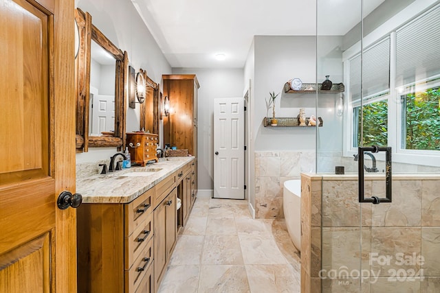 bathroom with independent shower and bath, vanity, and tile patterned flooring