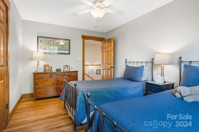 bedroom with ceiling fan and light hardwood / wood-style flooring