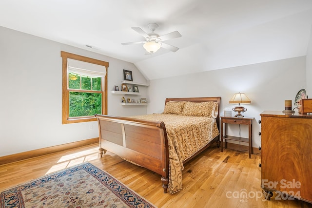 bedroom with light hardwood / wood-style flooring, lofted ceiling, and ceiling fan