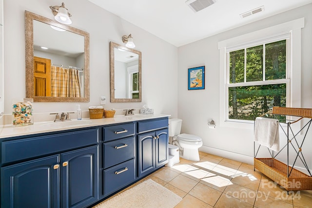 bathroom featuring tile patterned floors, vanity, and toilet