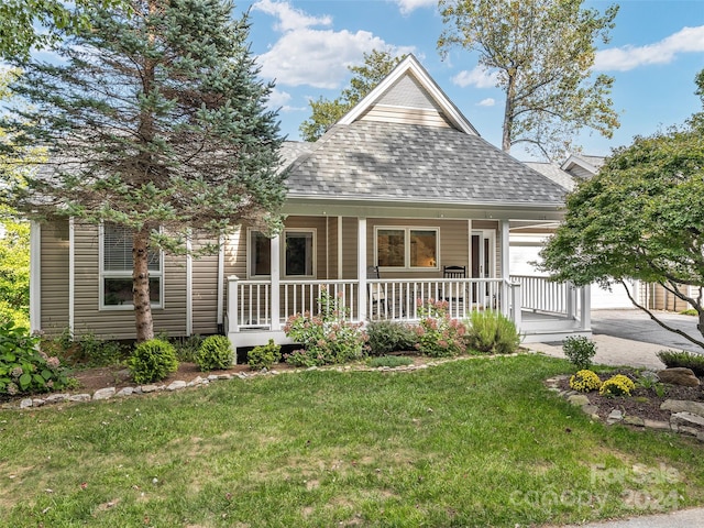 view of front of house with a front yard and a porch