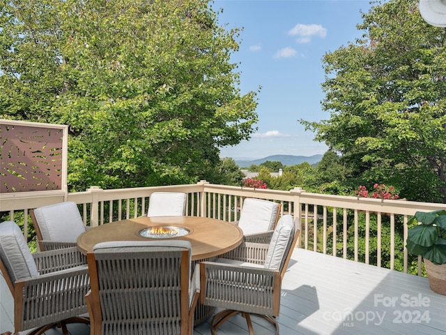 wooden deck with a mountain view