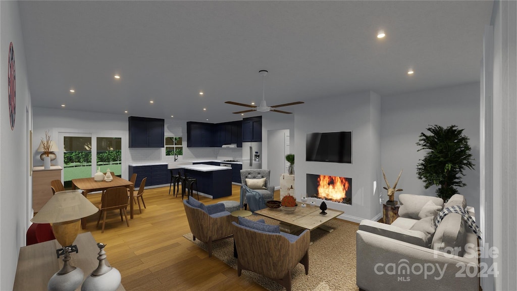 living room featuring ceiling fan and light hardwood / wood-style floors