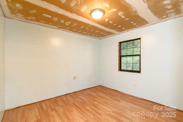 unfurnished room with wood-type flooring