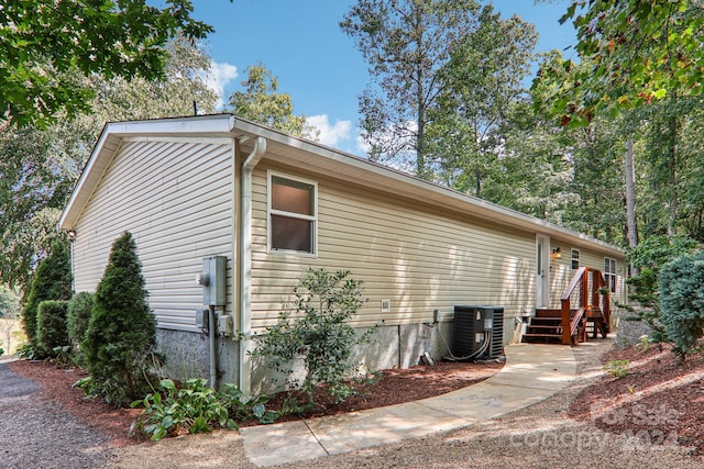 view of side of property with cooling unit