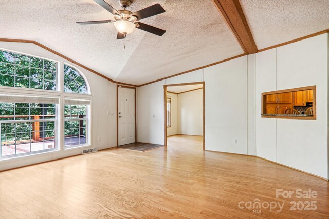 18 Spencer Rd, Candler, NC 28715 - empty room with vaulted ceiling, a textured ceiling, ceiling fan, wood finished floors, and ornamental molding