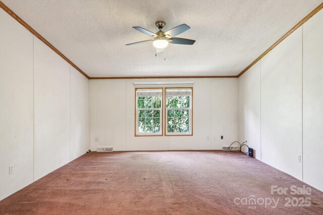 18 Spencer Rd, Candler, NC 28715 - carpeted empty room with ornamental molding, a textured ceiling, a ceiling fan, and a decorative wall