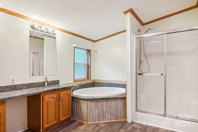 18 Spencer Rd, Candler, NC 28715 - bathroom featuring crown molding, a stall shower, a bath, wood finished floors, and vanity