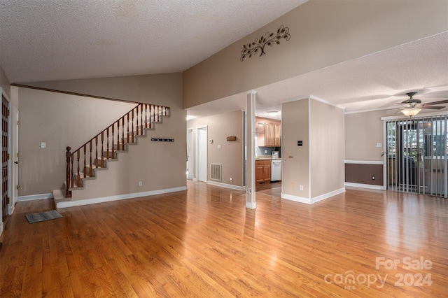 unfurnished living room with a textured ceiling, vaulted ceiling, hardwood / wood-style flooring, and ceiling fan