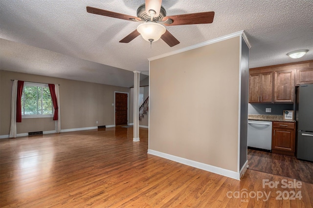 interior space featuring crown molding, a textured ceiling, and dark wood-type flooring