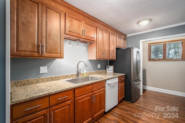 kitchen featuring sink, a textured ceiling, white dishwasher, dark wood-type flooring, and crown molding