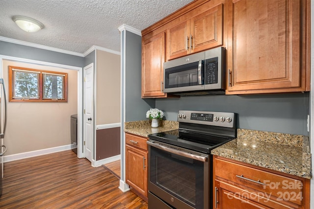 kitchen featuring appliances with stainless steel finishes, light stone countertops, a textured ceiling, dark wood-type flooring, and crown molding