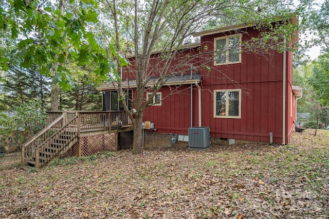 rear view of house with a deck and central AC unit