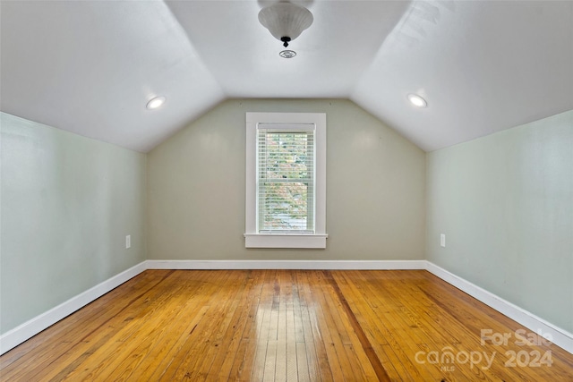 bonus room with wood-type flooring and lofted ceiling