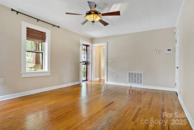 unfurnished room with hardwood / wood-style flooring and ceiling fan