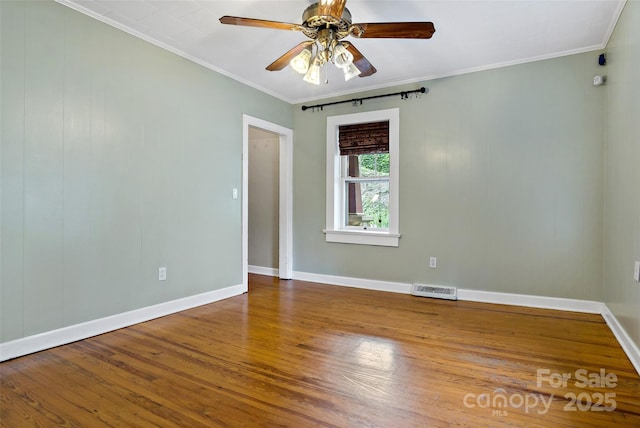 empty room with ceiling fan, ornamental molding, and hardwood / wood-style floors