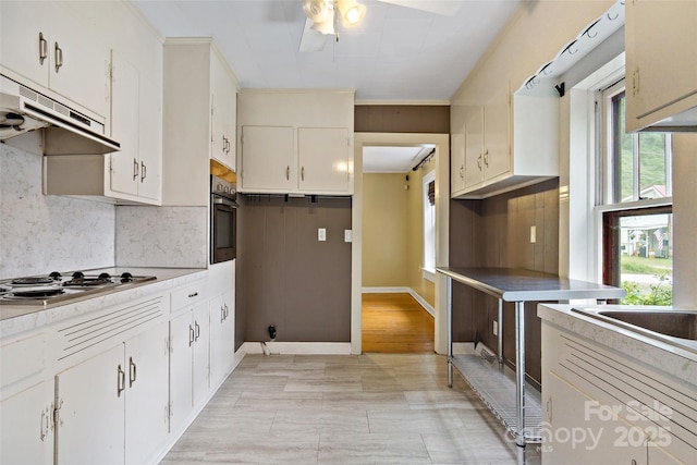 kitchen featuring tasteful backsplash, white cabinetry, and appliances with stainless steel finishes